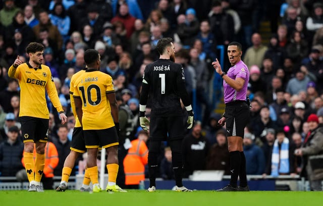 Referee Farai Hallam makes an announcement of no penalty following a VAR review 