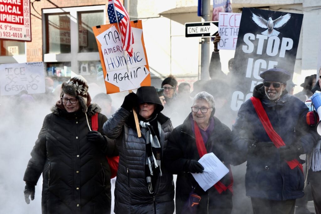 Bundled against the cold, protesters march through Center City from the Philadelphia Immigration Court at 9th and Market streets to the U.S. Immigration and Customs Enforcement ofices at 8th and Cherry streets.