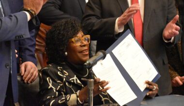 Mayor Cherelle Parker holds up a bill authorizing the PPA to reopen the intercity bus terminal after signing it Tuesday, Jan. 13, 2026.