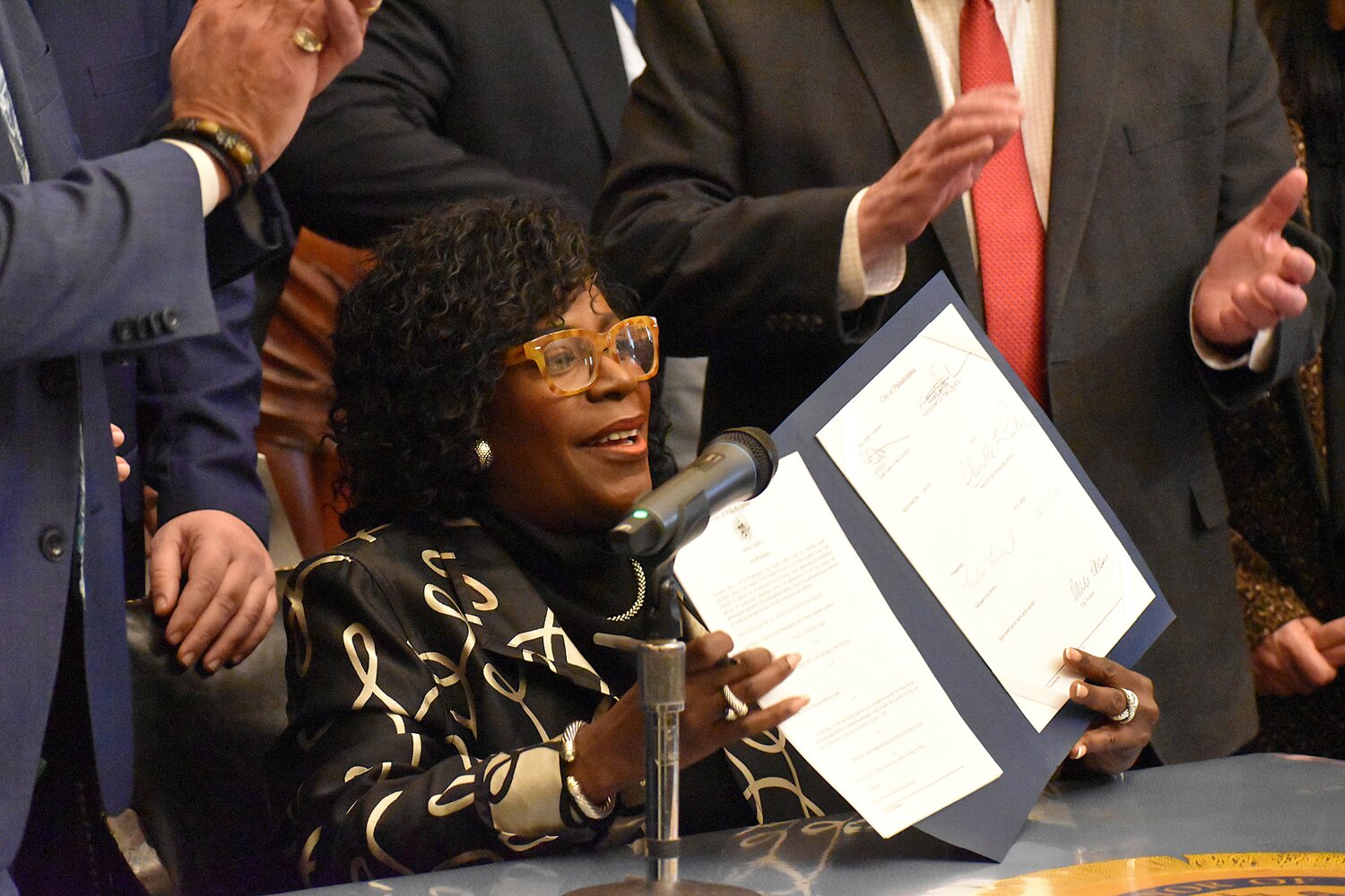 Mayor Cherelle Parker holds up a bill authorizing the PPA to reopen the intercity bus terminal after signing it Tuesday, Jan. 13, 2026.