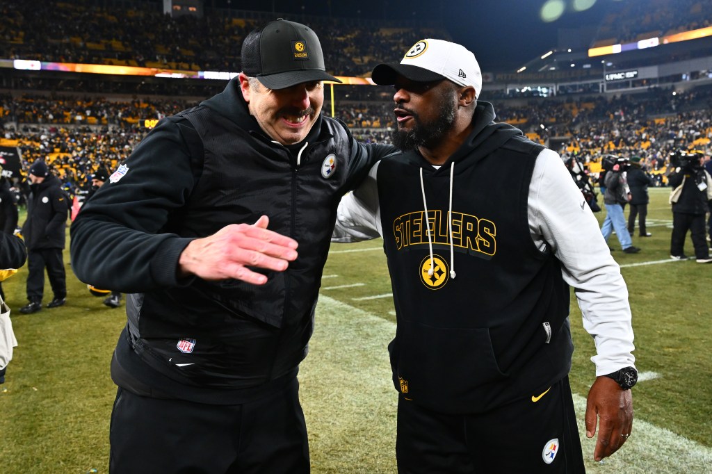 Offensive coordinator Arthur Smith and head coach Mike Tomlin of the Pittsburgh Steelers celebrate after defeating the Baltimore Ravens at Acrisure Stadium on January 4, 2026 in Pittsburgh, Pennsylvania.