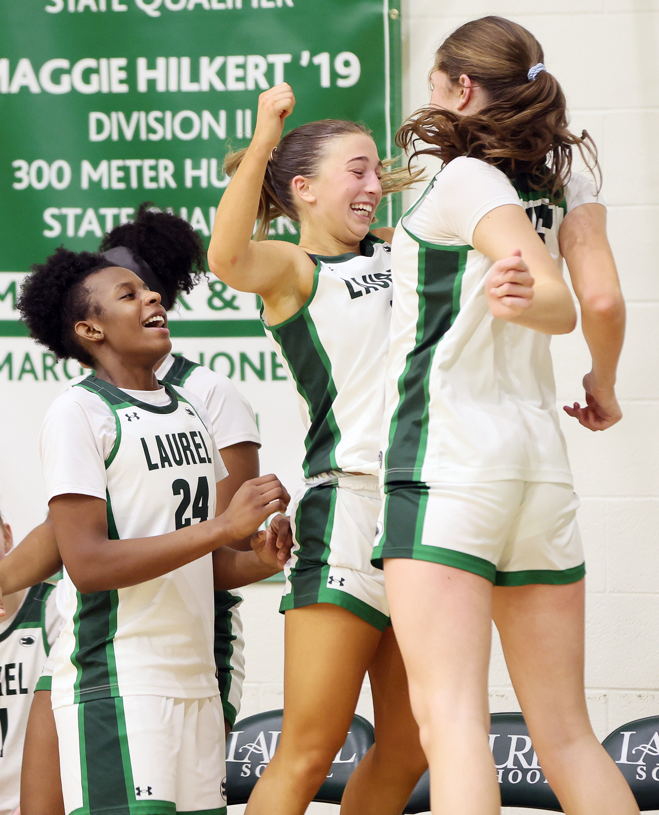 Laurel's Reese Grammes (C) and Laurel's Cia Ferrante (R) celebrate a score as Laurel's Tristan Williams joins in the second half fun.  