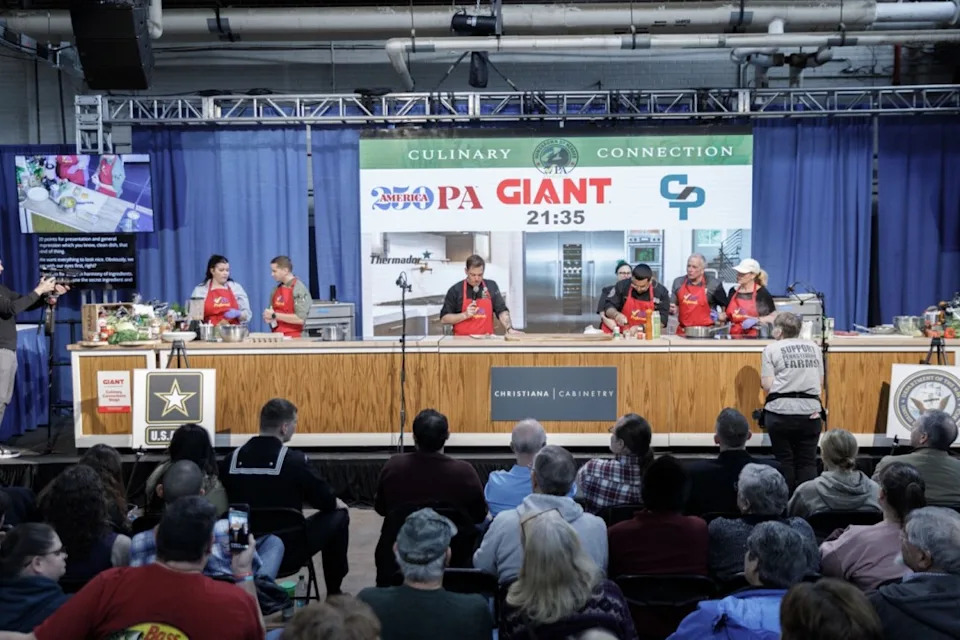 Army Sgt. Nicolas Adame and Navy Culinary Specialist Second Class Jonathan Ortiz and teammates competed head-to-head at the at the Farm Show’s 2026 Army vs. Navy Cookoff using Pennsylvania-grown ingredients, highlighting the connection between the Commonwealth’s agricultural producers and the military’s commitment to nutrition, readiness, and excellence.