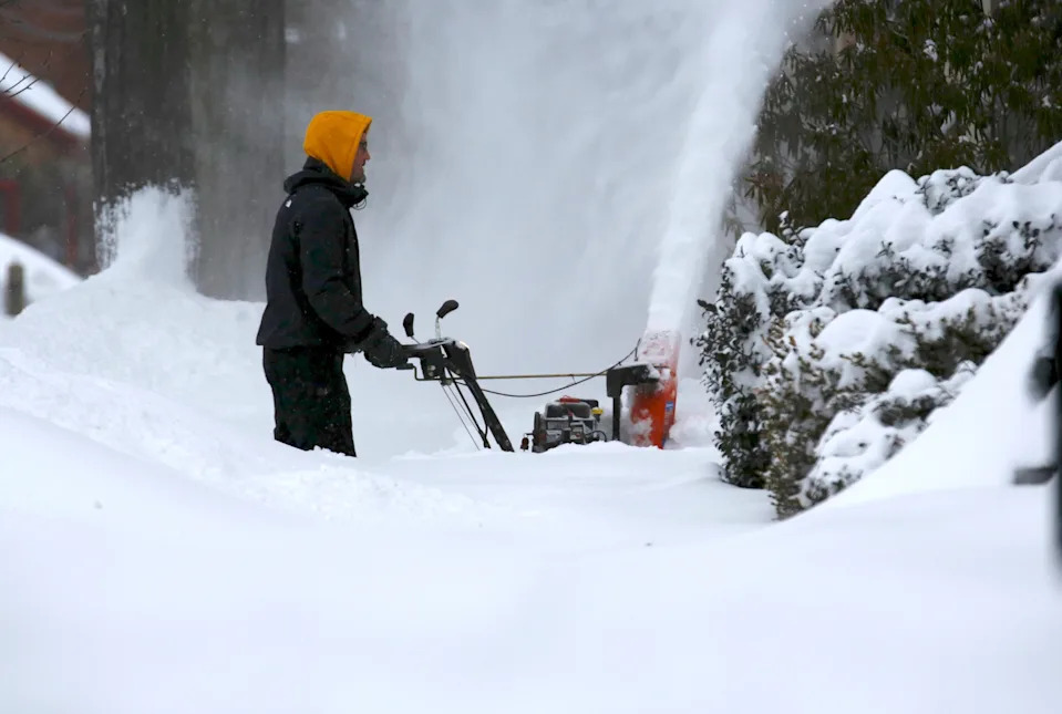 A person blows snow after a storm in Portsmouth, N.H. on Jan. 26.