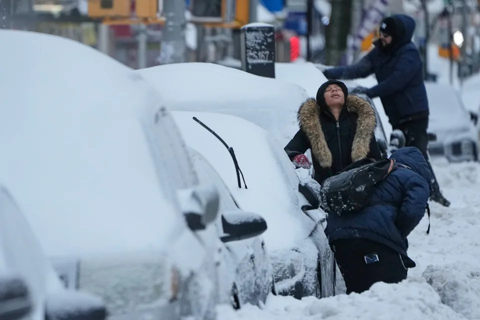 Jaylean Melvin takes a break from trying to clear her car of snow in New York on Jan. 26.