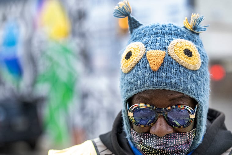 Crossing guard Terri Ashwood shields her head and face from cold winds in November. Those winds are about to get colder this week.