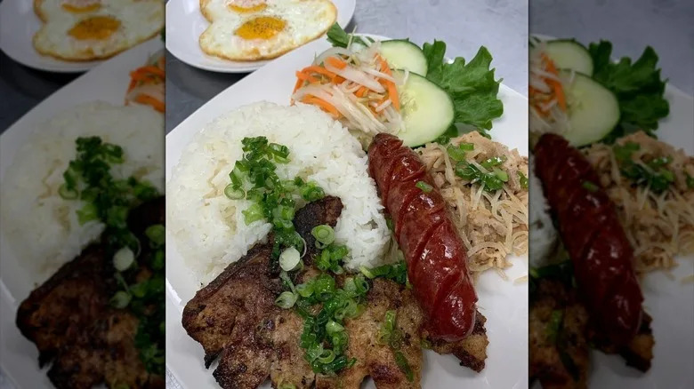 Plate of rice, meat, sausage, and veggies from Cafe Nhan