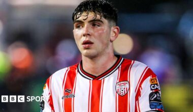 Sean Patton, wearing a red and white vertical striped shirt, in action for Derry City