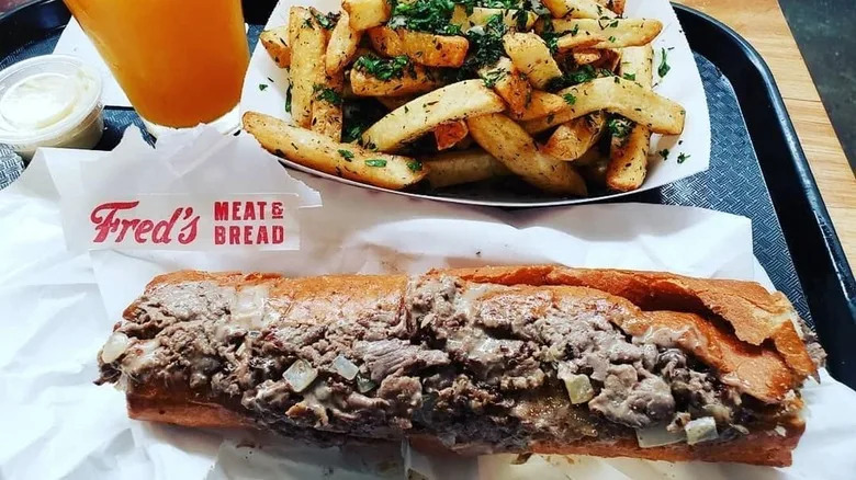 A Philly cheesesteak served with fries from Fred's Meat & Bread in Atlanta, Georgia