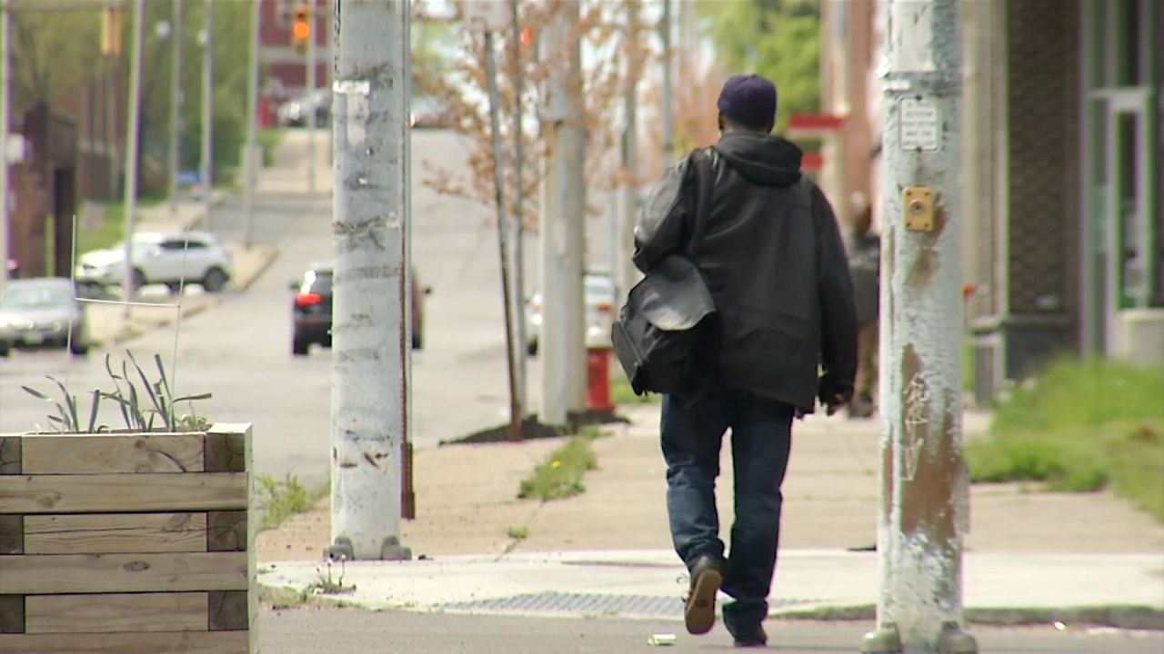 man walking down a buffalo street