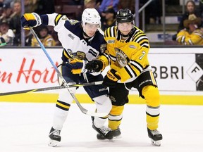 Sarnia Sting's Jacob Reese (7) checks Erie Otters' Lucas Ambrosio (73) at Progressive Auto Sales Arena in Sarnia, Ont., on Friday, Jan. 9, 2026. Mark Malone/Chatham Daily News/Postmedia Network