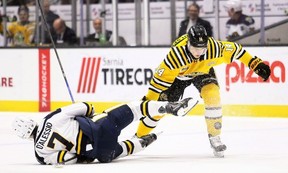 Sarnia Sting's Jack Van Volsen (14) knocks down Erie Otters' Michael D'Alessio (7) while battling for the puck at Progressive Auto Sales Arena in Sarnia, Ont., on Friday, Jan. 9, 2026. Mark Malone/Chatham Daily News/Postmedia Network