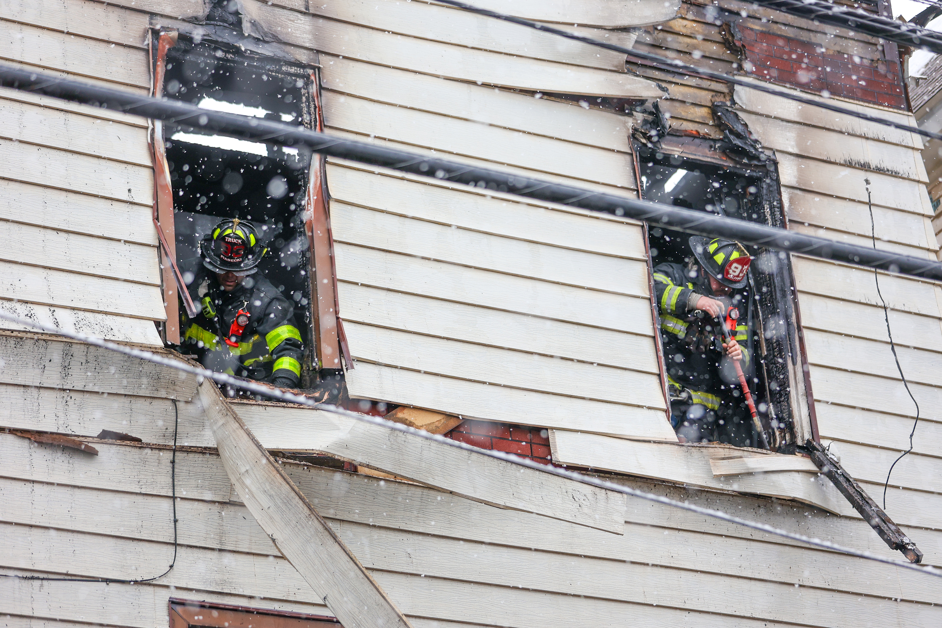 Firefighters work on 628-630 McAlpine St. in Avoca early Saturday...