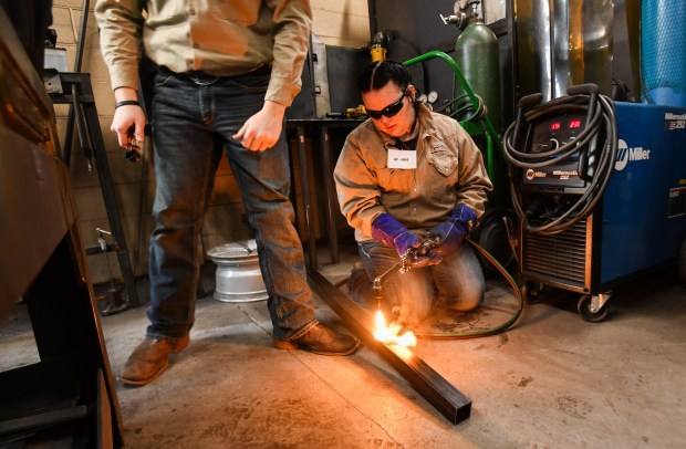 West Side Career and Technology Center student Amelia Teasdale prepares to cut a piece of metal during the District 1 SkillsUSA Regional Competition held at Luzerne County Community College in Nanticoke Thursday, January 8, 2026. (SEAN MCKEAG / STAFF PHOTOGRAPHER)