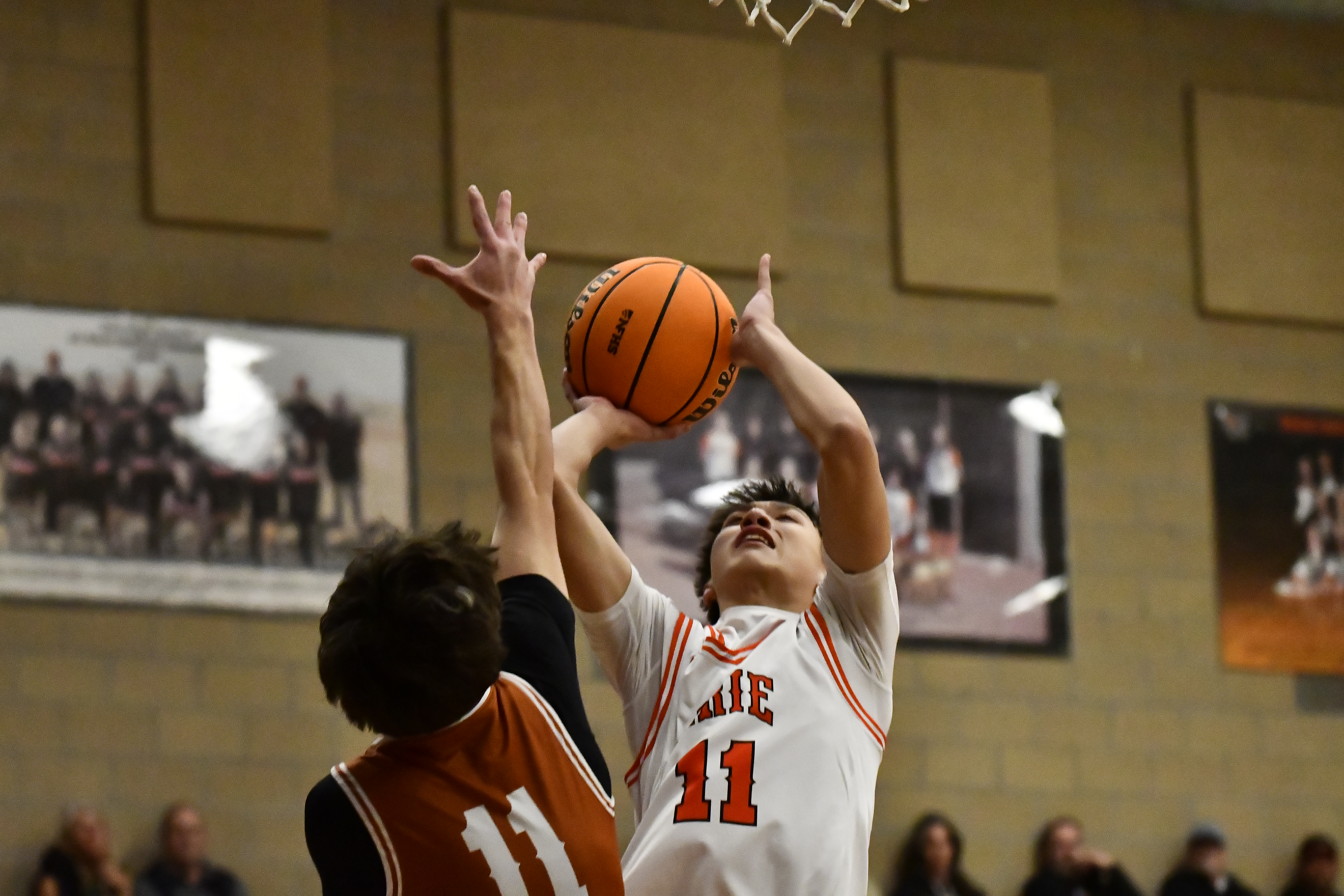 Erie's Tyler Firebaugh takes a shot as Mead's Samuel Brennan...