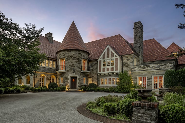 The fieldstone house for sale for $7.9 million on Creighton Road in Lower Merion includes an entrance tower with a chandelier and winding staircase.