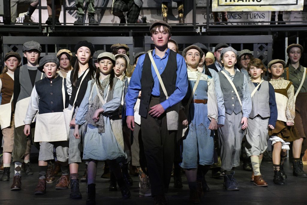 students dancing in costume on stage