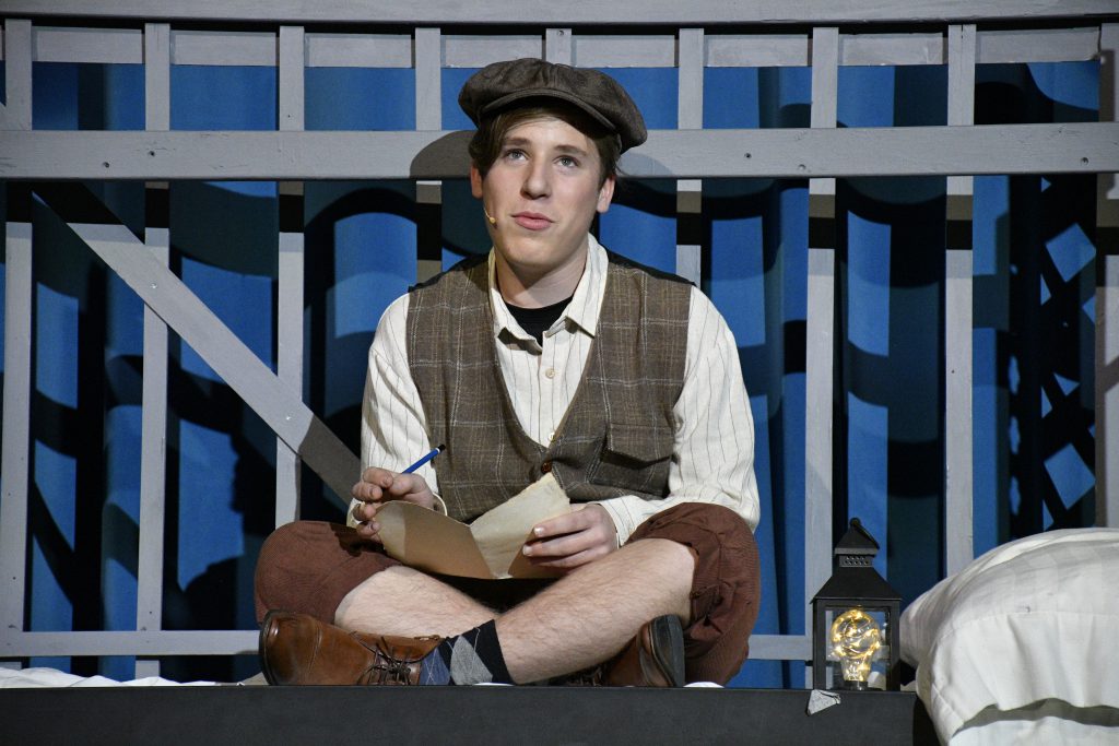 student performing in costume on stage