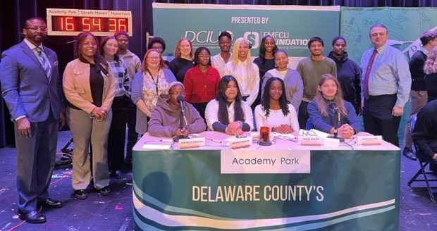The Academy Park Delco Hi-Q team is pictured taking the stage alongside distinguished guests. Academy Park High School in Sharon Hill hosted Strath Haven and Haverford High Schools in a Hi-Q match earlier this month. (COURTESY OF DELCO HI-Q)