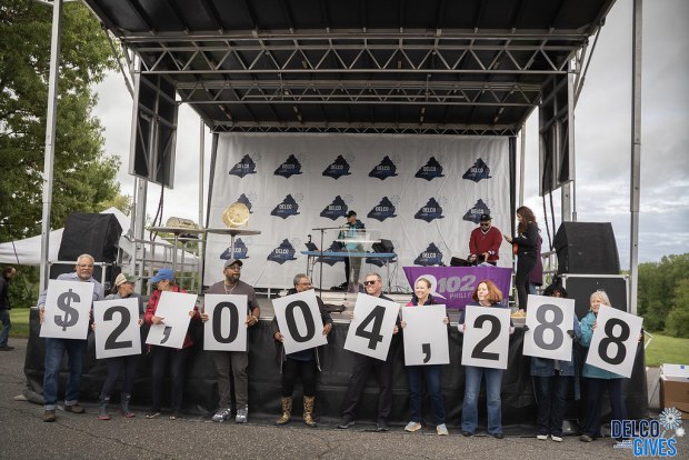 Delco Gives organizers hold up numbers during the celebratory event at Rose Tree Park last week, to show growing numbers in the results of this year's Delco Gives campaign. (COURTESY OF FOUNDATION FOR DELAWARE COUNTY)