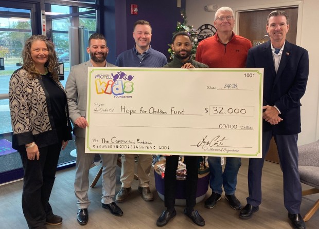Members of the Propell Kids' Foundation (PKF) presented the proceeds of their recent golf outing to The Community's Foundation (TCF) for local children and families in need. At the presentation, from left, Diedre Konar, TCF; Ryan Conte, PKF; Kevin Morrissey, PKF; Marc Dungee, PKF; Tom Southmayd, TCF; and Gary Golden, CEO of Propell Credit Union. (COURTESY OF PROPELL)