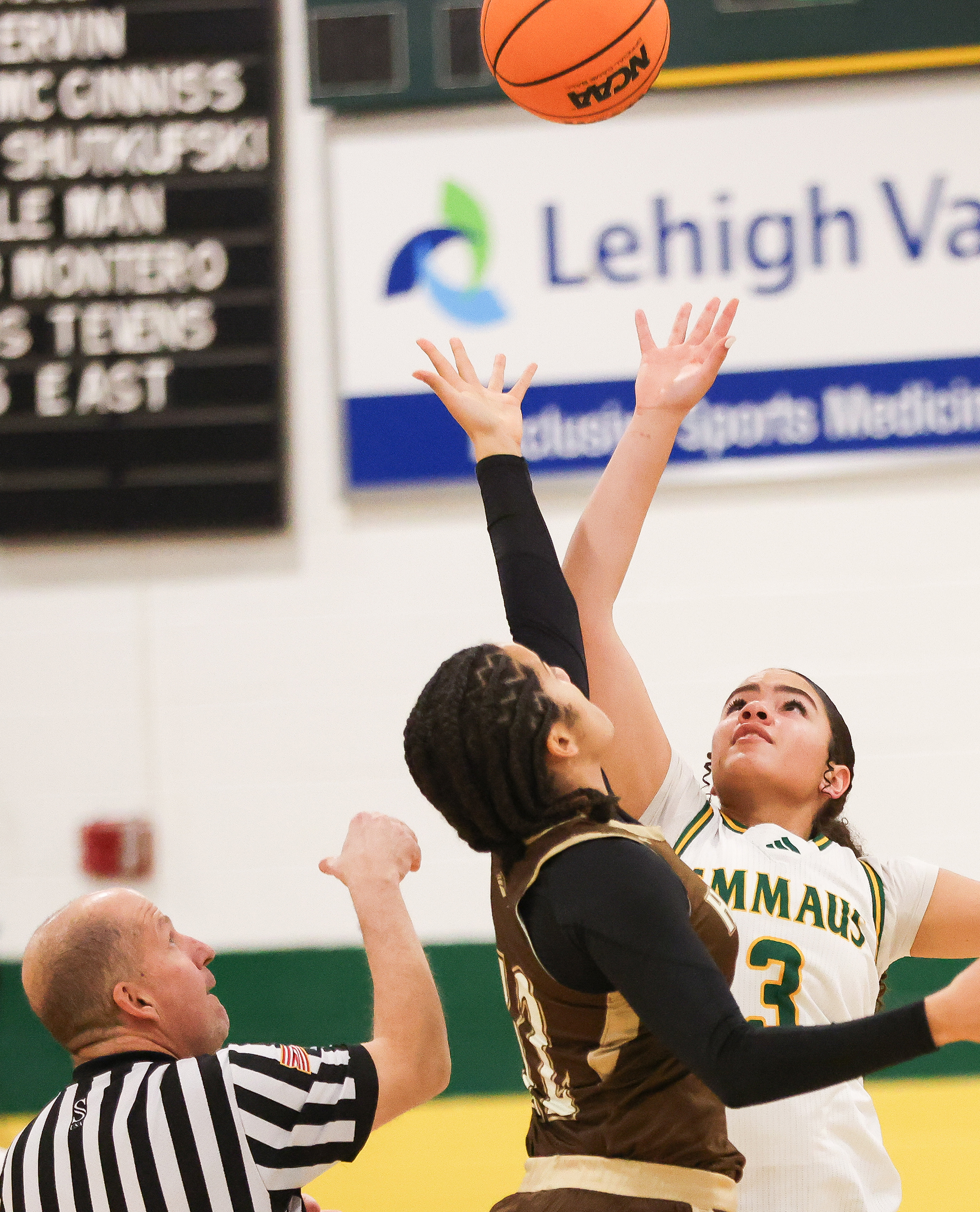 Emmaus player Eva Glover (3) and Bethlehem Catholic's Ayva Radande (12) try to get the jump ball at the begining of the game at Emmaus on Jan. 12, 2026.