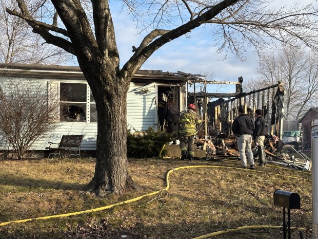 Fire officers and Berks County deputy coroners prepare to remove the body of a fire victim from a home in the 1200 block of Dauphin Place in Exeter Township after a fire Wednesday morning. (STEVEN HENSHAW - READING EAGLE)