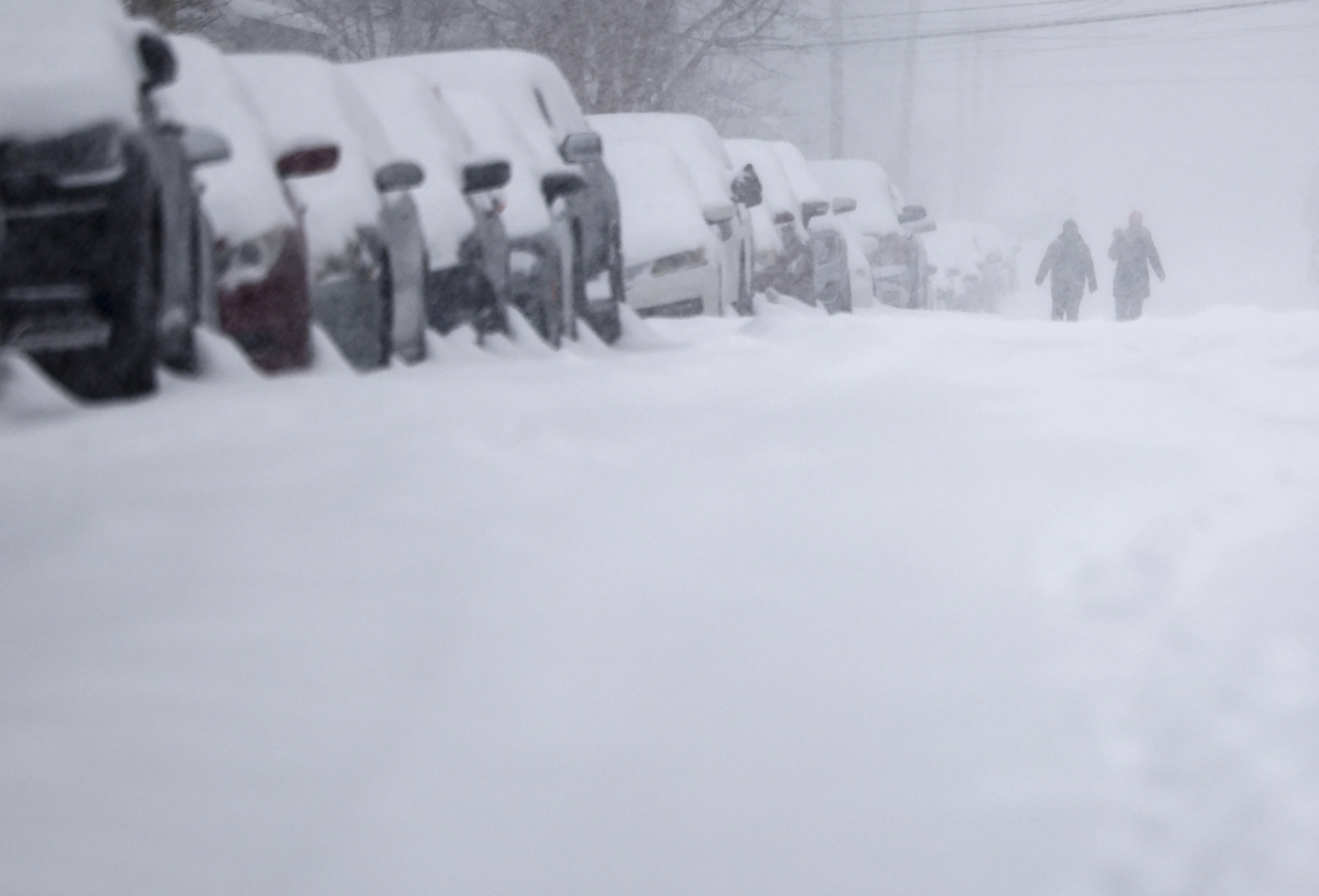 People go for a walk in the snow on Church Street in Easton Sunday, Jan 25, 2026. 