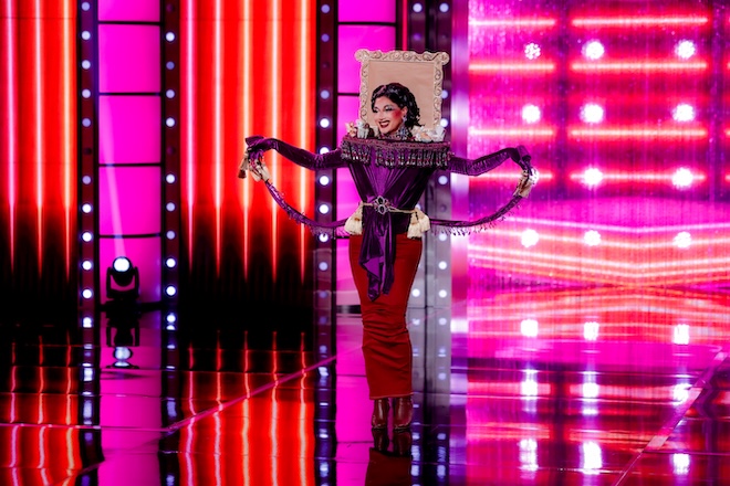 Mango Mandy, a Filipino American drag queen in a purple and burgundy gown on stage on RuPaul's Drag Race.