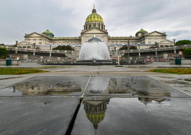 The Pennsylvania State Capitol is reflected on the ground June 30, 2025, in Harrisburg, Pa. (AP Photo/Aimee Dilger, File)