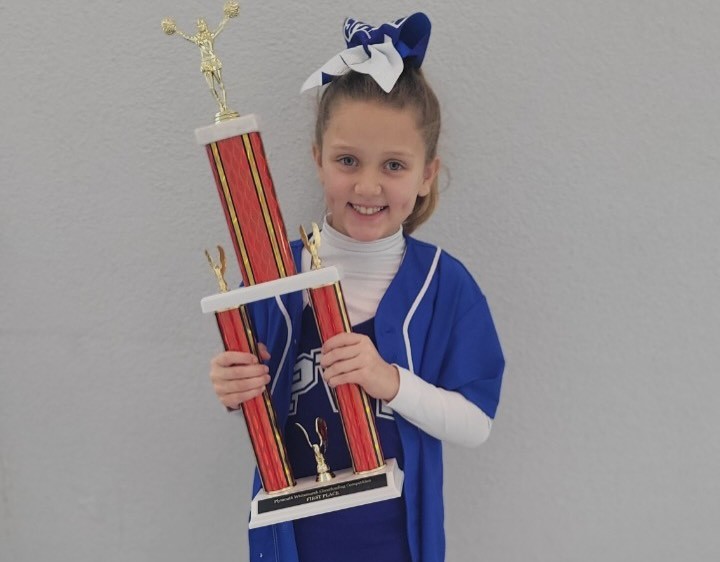 Sabrina Cantor holds the championship trophy from her Plymouth Valley...