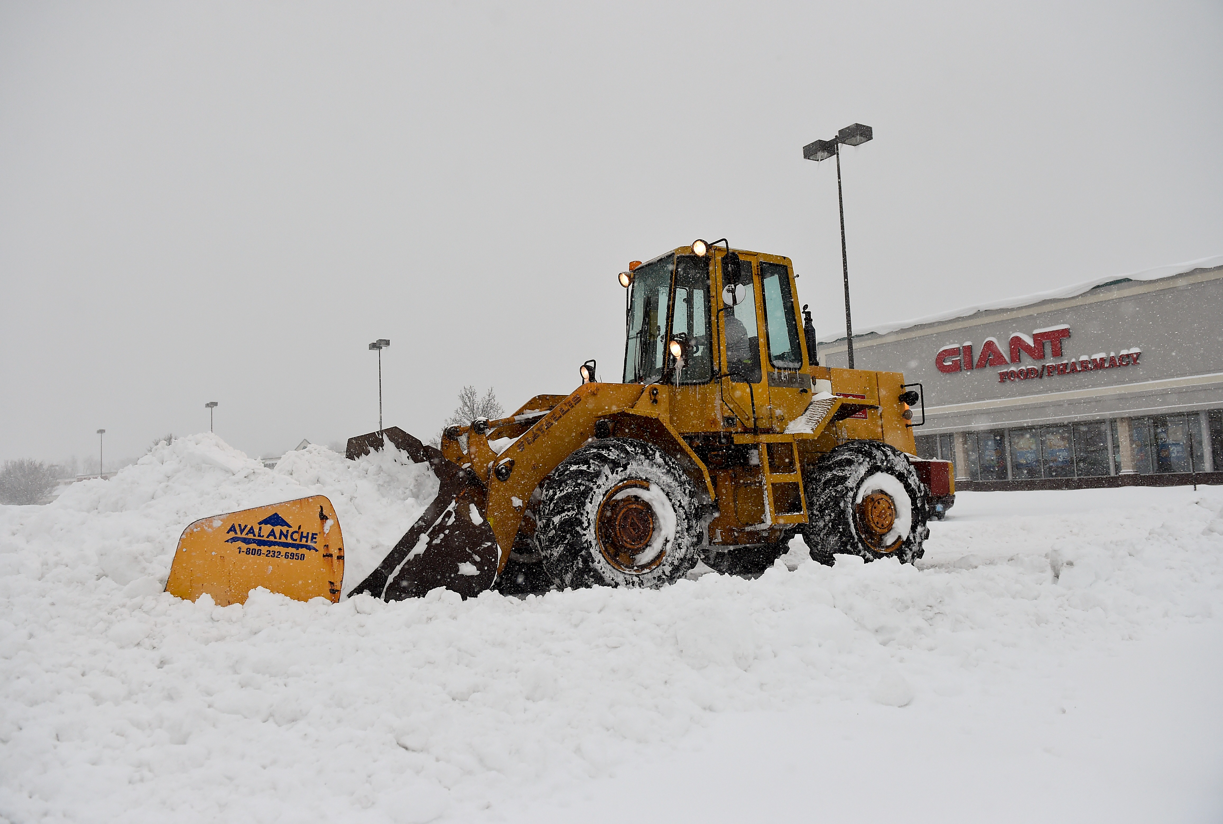 An excavator is used to clear Spring Towne Center in...