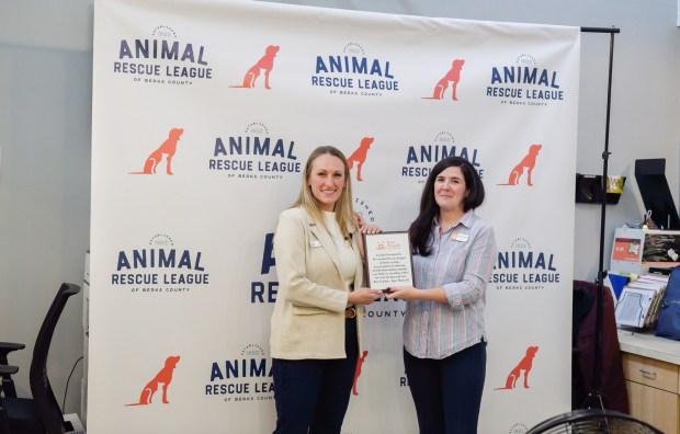 Ashley Mikulsky, Animal Rescue League of Berks County chief executive officer, left, receives recognition of the shelter's no-kill status from Carolyn Fitzgerald, senior strategist with Best Friends Animal Society. (COURTESY OF ANIMAL RESCUE LEAGUE OF BERKS COUNTY)