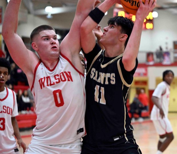 Berks Catholic's Johnny Giesa challenges Wilson's Michael Glover inside in a 50-38 Saints' victory over the Bulldogs on Monday, Jan. 19, 2026, at West Lawn. (BILL UHRICH/READING EAGLE)