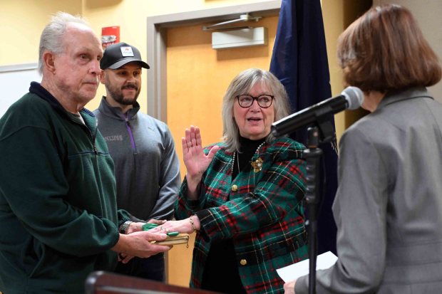 Reading City Council President Donna Reed is administered the oath of office by City Clerk Linda A. Kelleher as Reed's husband, Tom Knause, and son Harry Knause hold the Bible during an inauguration ceremony in the Schmidt Training and Technology Center at Reading Area Community College on Monday, Jan. 5, 2026. (BILL UHRICH/READING EAGLE)