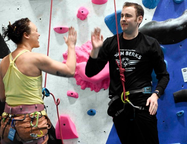 Krista Weller high fives Nathan Creveling after his successful climb during an IM ABLE foundation adaptive rock climbing session at Reading Rocks Climbing and Fitness, 550 George St., Muhlenberg Township. (BILL UHRICH/READING EAGLE)