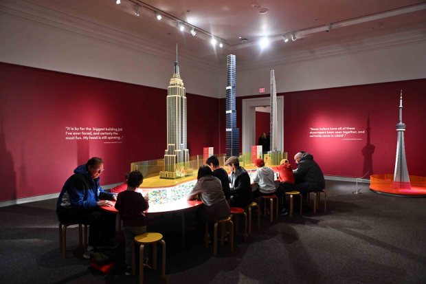 Adults and children put together LEGO bricks during the Towers of Tomorrow with LEGO Bricks exhibit at the Reading Public Museum on Saturday, Jan. 31, 2026. (BILL UHRICH/READING EAGLE)