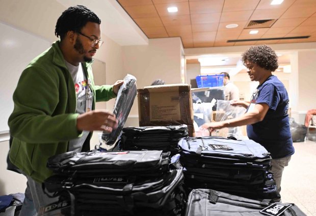 Jordan Hines, specialist for cultrue and belonging, left, Jewel Hawkins from the microbiology lab at Reading Hospital prepare backpacks during a Martin Luther King Jr. Day of Service on Monday, Jan. 19, 2026. (Bill UHRICH/READING EAGLE) (Bill UHRICH/READING EAGLE)