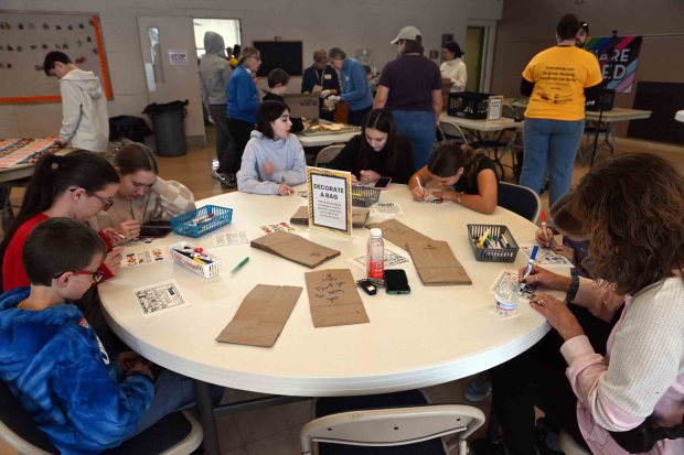 Students write messages on lunch bags at Immanuel UCC in Shillington during Martin Luther King Jr. Day of Service on Monday, Jan. 19, 2026. (BILL UHRICH/READING EAGLE)