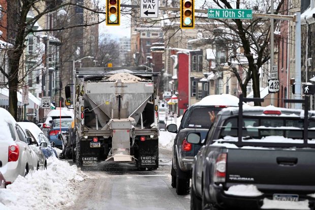 A city of Reading Public Works truck plows and salts the 1000 block of Washington Street on Monday, Jan. 26, 2026. (BILL UHRICH/READING EAGLE)