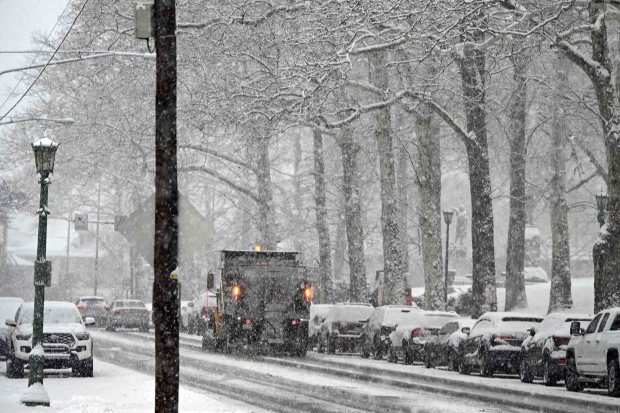 A PennDOT salt truck works Perkiomen Avenue in Reading during the Saturday morning snowstorm. (Bill UHRICH/READING EAGLE)