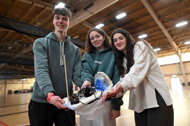 Lucas Scheck, 17, Bella Cooper, 15, and Tessa Sosko, 15, all from Boyertown High School, prepare their hovercraft for competition during the Berks County Science Olympiad at Kutztown University on Thursday, Jan. 8, 2026. (BILL UHRICH/READING EAGLE)