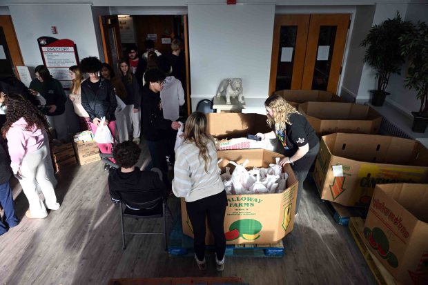 Wilson High School sophomores place weekend lunch bags into boxes for distribution during a districtwide day of service on Friday, Jan. 16, 2026. (BILL UHRICH/READING EAGLE)