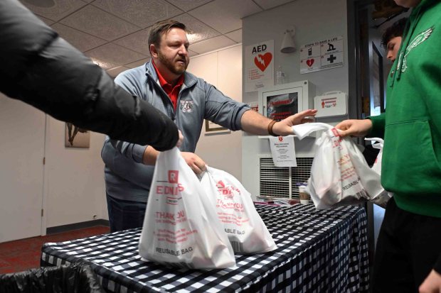 Dr. Andy Hoffert, Wilson School District assistant superintendent collects packed weekend lunch bags during a districtwide day of service on Friday, Jan. 16, 2026. (BILL UHRICH/READING EAGLE)