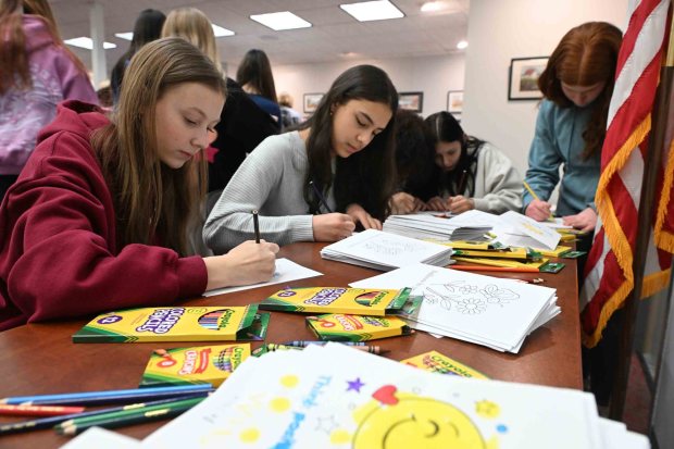 Wilson High School sophomores Clair Volker, 15, left, and Angela Good, 16, make cards for the weekend lunch bags during a districtwide day of service on Friday, Jan. 16, 2026. (BILL UHRICH/READING EAGLE)