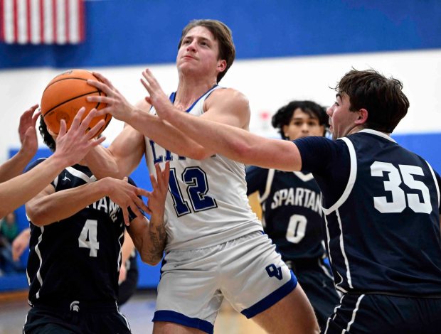 Oley Valley's Luke Turchi drives and is fouled for a three-point play as he scores 26 points against Wyomissing in a 71-69 Spartans' double-overtime victory over the Lynx on Friday, Jan. 16, 2026, at Oley. (Bill UHRICH/READING EAGLE)