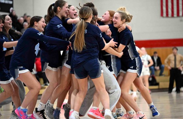Wyomissing's Ella Anders, second from right, is mobbed by teammates following her game-winning free throws against Schuylkill Valley in a 42-41 Spartans victory over the Panthers on Tuesday, Jan. 20, 2026, at Leesport. (BILL UHRICH/READING EAGLE)