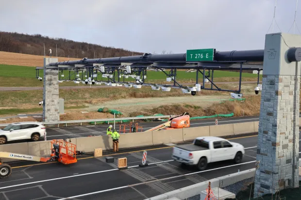 Workers install equipment for the open-road tolling system on the Pennsylvania Turnpike west of Berks County at milepost 276.2 between the Reading and Lebanon-Lancaster interchanges. (Courtesy of Pennsylvania Turnpike)