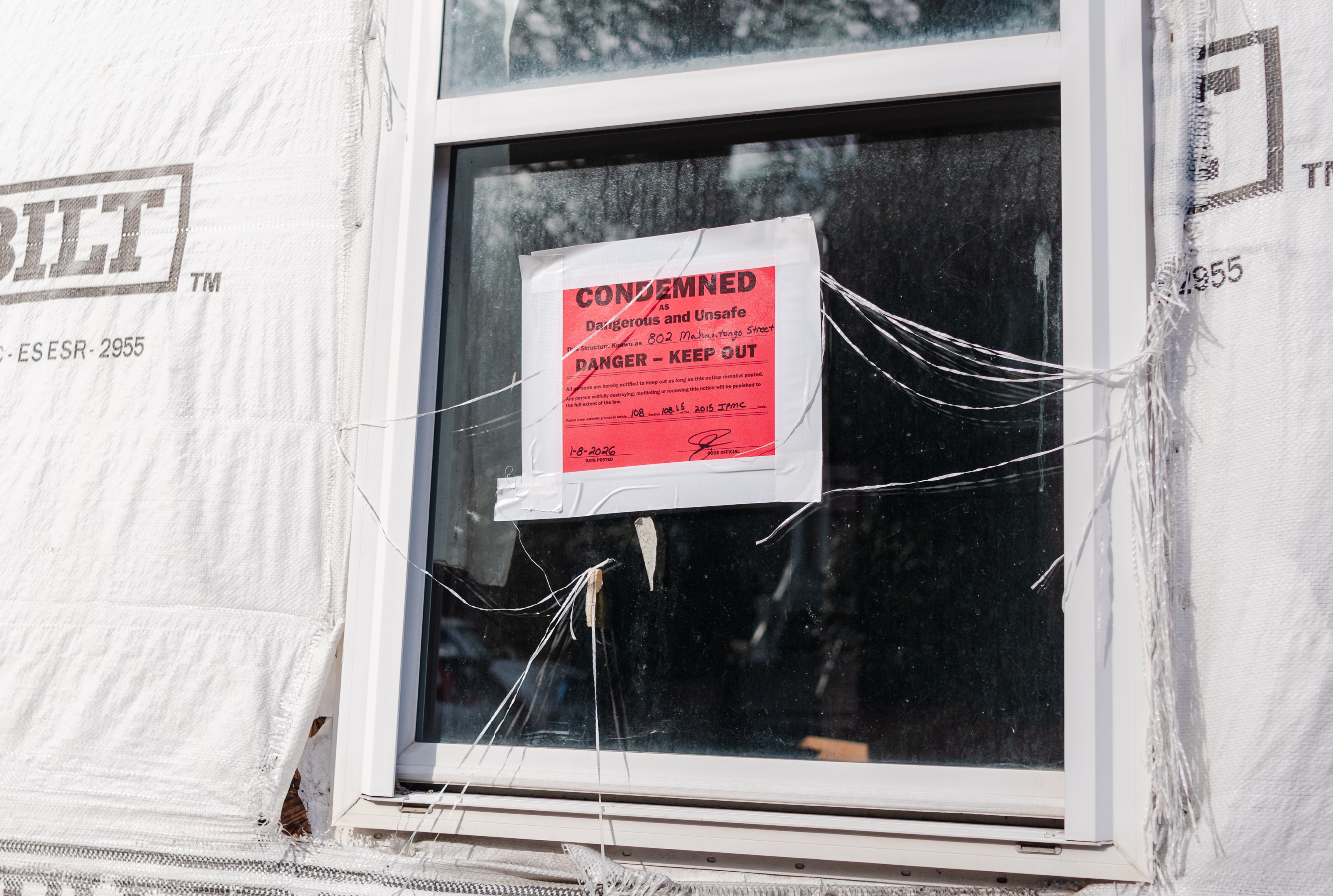 A “Condemned” sign hangs in a window of 802 Mahantongo...