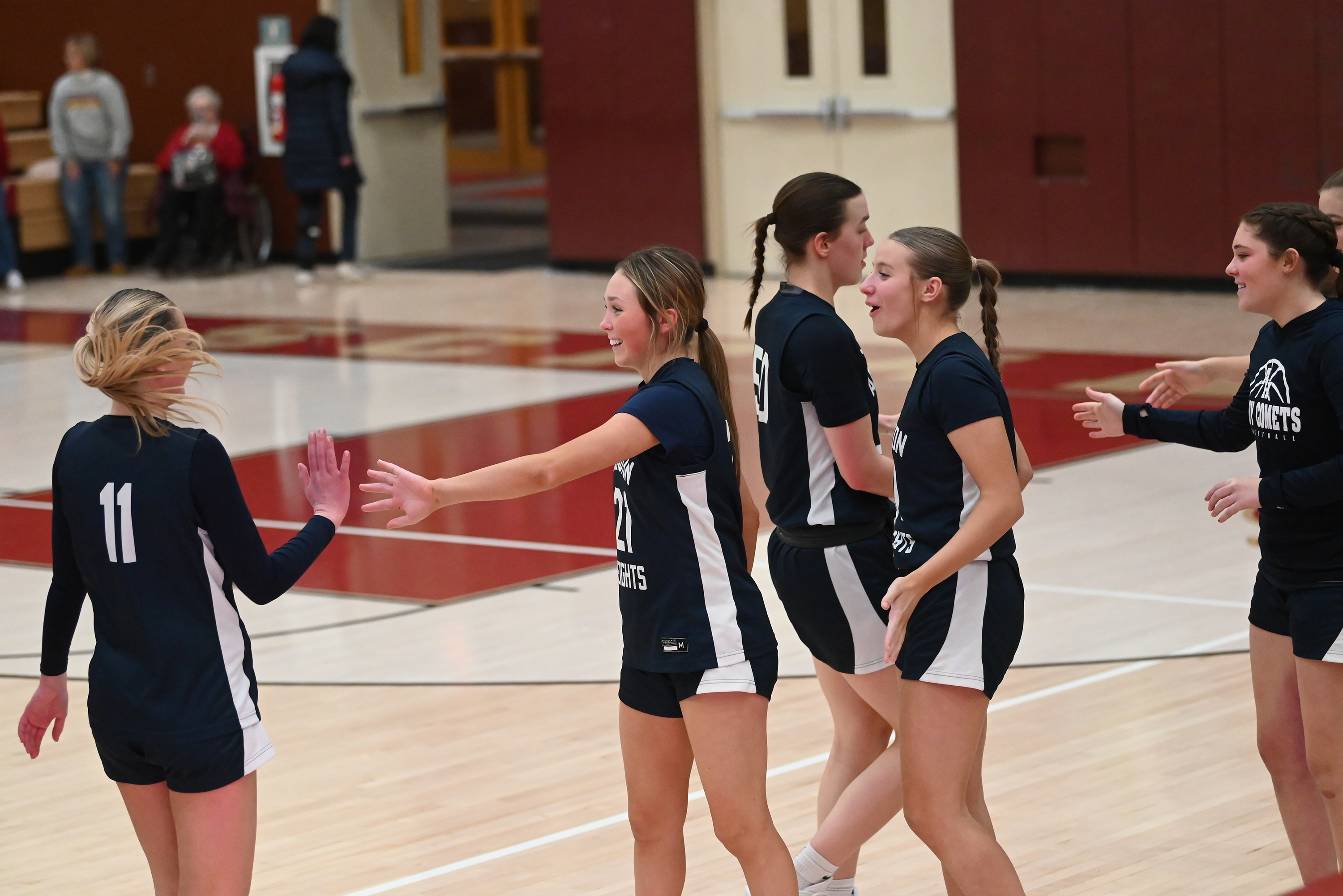 Abington Heights players celebrate after defeating Scranton in the basketball...